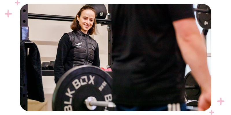 Charlotte Price of Hunt Fitness supervising a weightlifter