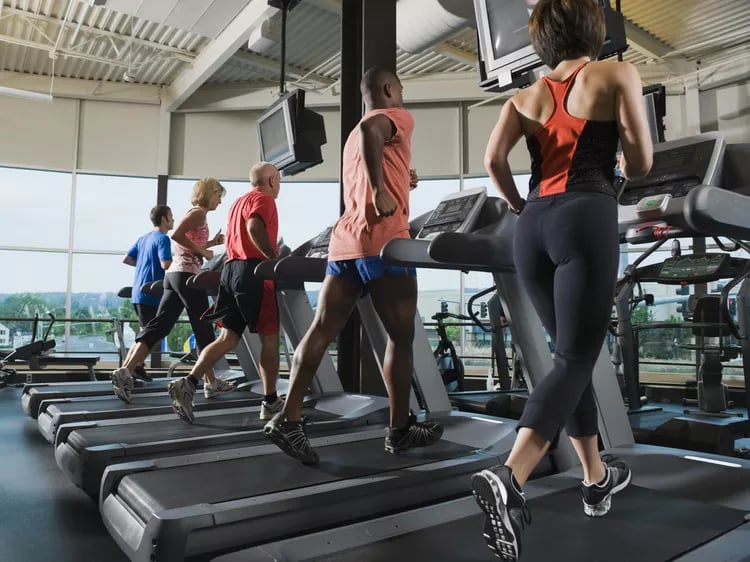 Members running on treadmills in a 24-hour access gym.