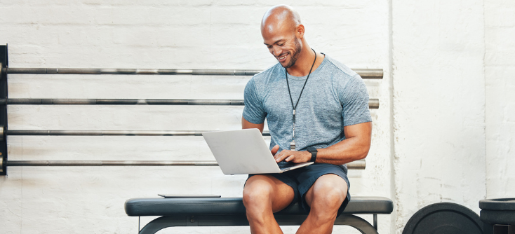 A fitness instructor checking his fitness business's reports