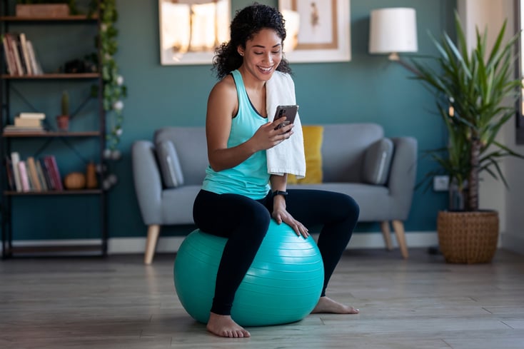 A fitness owner using gym management software on their phone.