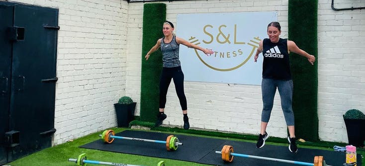 Two participants taking part in an outdoor workout session