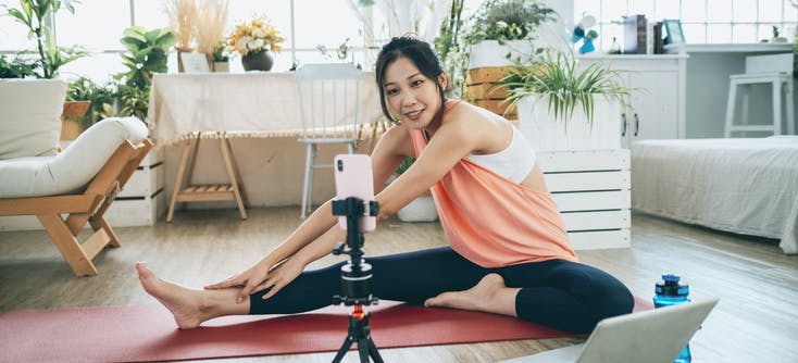 girl giving an online fitness class at home