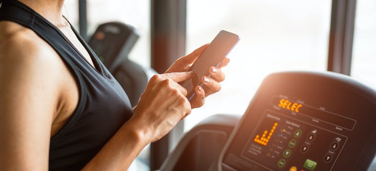 a woman paying for her gym classes via her phone