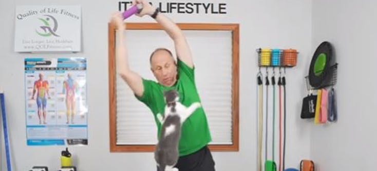 Ron Dorr and his cat lead an fitness class