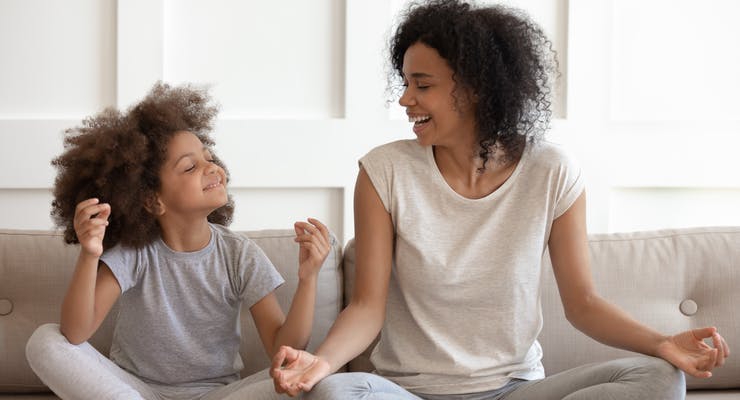 mother and daughter practicing yoga