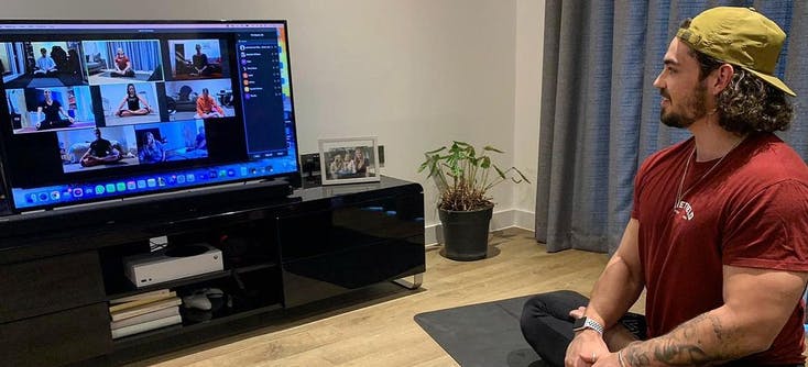 A personal trainer leads a session from his living room.