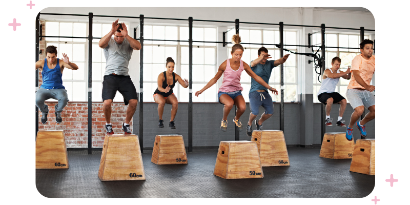 An exercise group taking part in a fitness challenge in a fitness facility