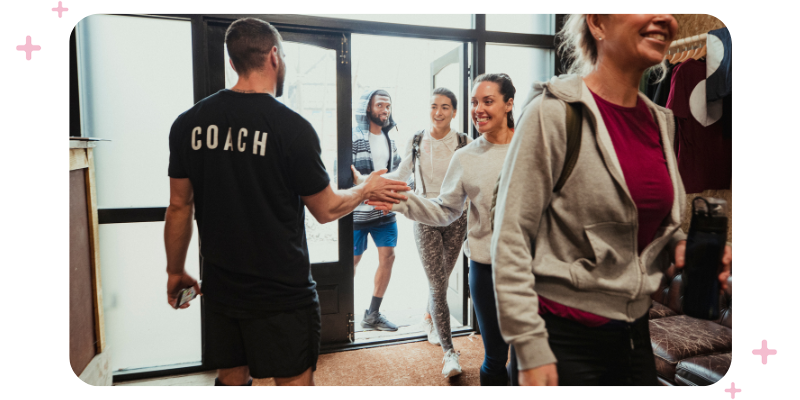 An instructor welcoming new yoga clients to their yoga studio business