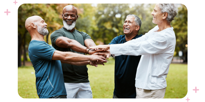 A group of men exercising outdoors and low-fiving.