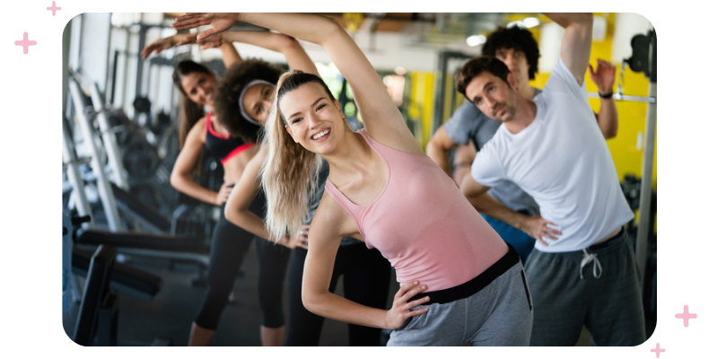 People doing a fitness class at a gym.