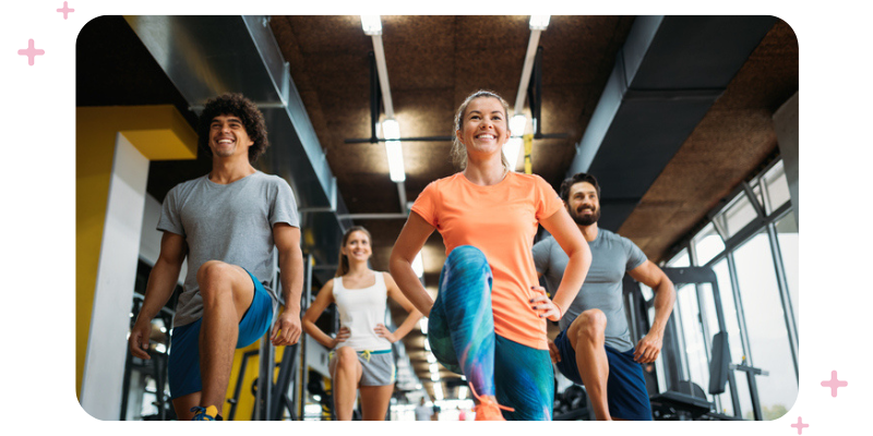 People doing a group fitness class at a gym.