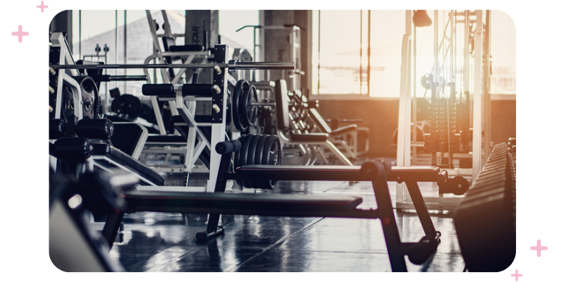 An empty gym with lots of exercise machines and equipment.