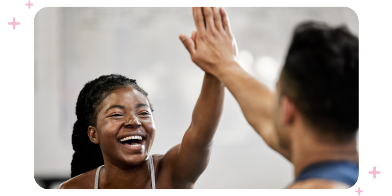 Fitness business owner high-fiving a client.