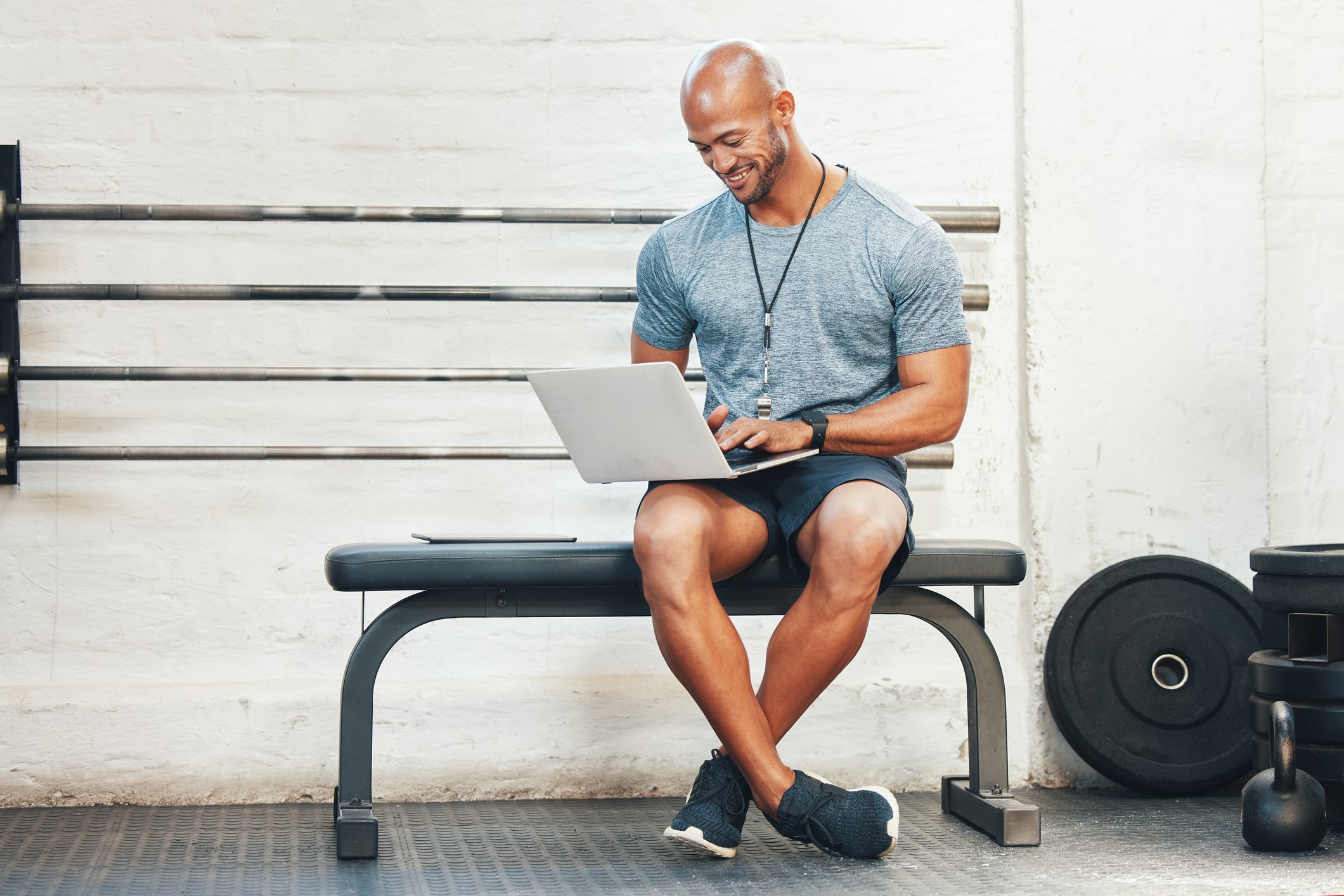 A gym owner using gym management software in his gym.