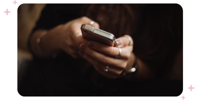 A woman's hands holding a mobile phone.