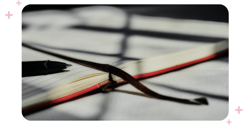 A picture showing a planner and a pen.