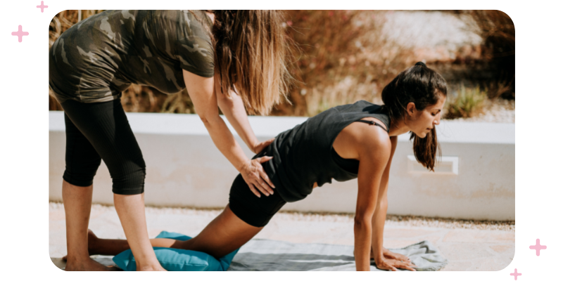 Personal trainer training a client in the park.