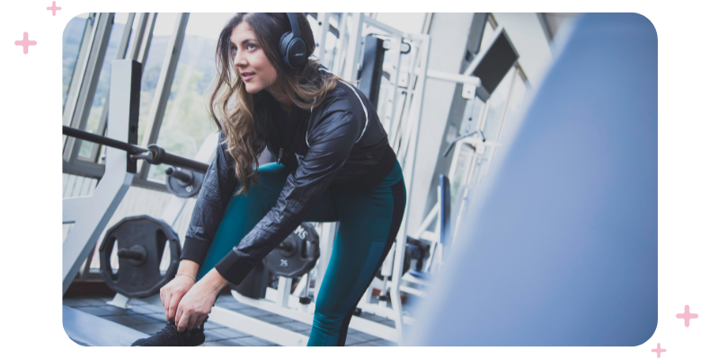 A fitness business owner recording herself while demonstrating a move.