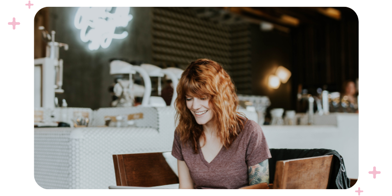 Woman working on her laptop in a coffee shop.